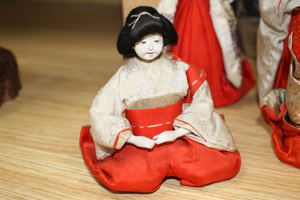 A set of five Japanese late Meiji period Hinamatsuri lacquered wood and fabric female dolls and five similar male dolls, all kneeling w